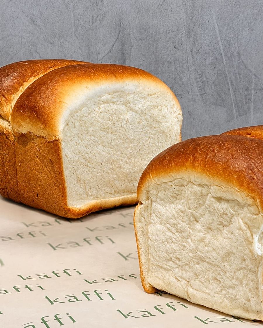 Kāffi milk bread loaves resting on branded paper, Colombo