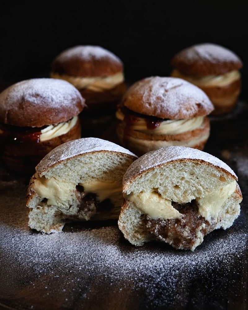 Semla buns cut open to show cream and almond filling